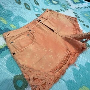 Free people distressed and lace hem jean short with bleach dye effect